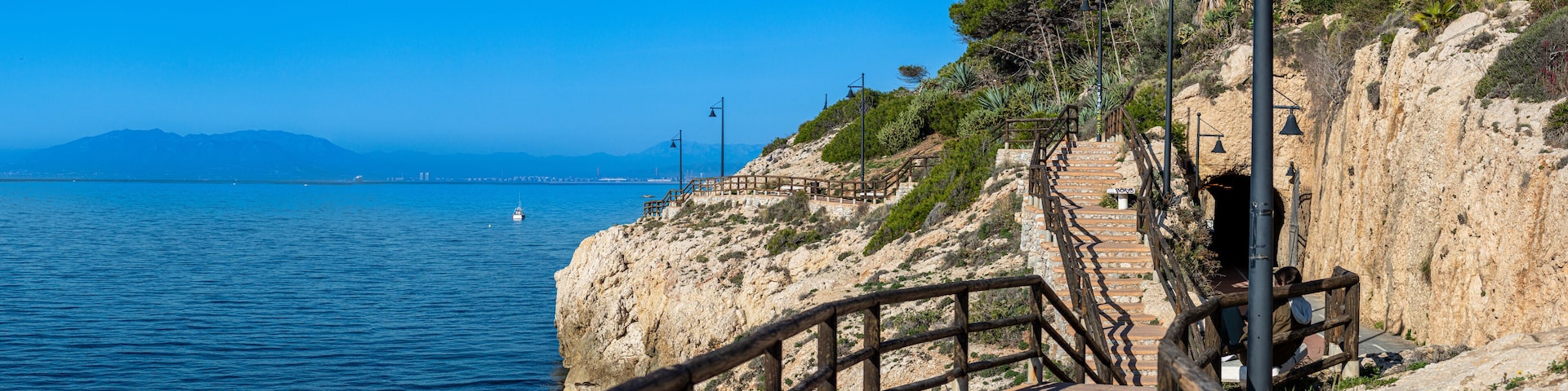 Morning walking on paths above rocks and through "El Cantal" tunnels in Rincon de la Victoria, Spain