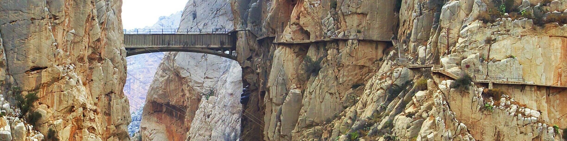 "The King's Little Pathway" spans the El Chorro gorge at a height of 100m. It was built in the early 1900s as an access path between nearby hydroelectric plants. The bridge got it's name in 1921 when King Alfonso XIII crossed it to help inaugurate a new dam.
The path rises to the bridge from either side of the gorge, snaking dramatically along the sheer cliff face. In recent years the path has been closed to all but rock-climbers, as many portions of the pathway had crumbled away.
However, the Spanish government recently completed a three-year restoration of the pathway, including guardrails, and it just opened yesterday - March 28, 2015! The 6€ entrance fee will be waived for the first six months, but you'll need to make reservations in advance: http://bit.ly/1BzhH8Y. Also, bear in mind that the path is one-way, so check the return bus schedule, or book a return crossing as well!
Lonely Planet has ranked the new pathway as one of the hottest new travel experiences for 2015. And finally, here is a link to a cool video of the restoration process: http://bit.ly/1vCkulv