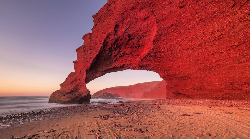 Sunset at red arches of Legzira beach, Sidi Ifni, Souss-Massa-Draa, Morocco.