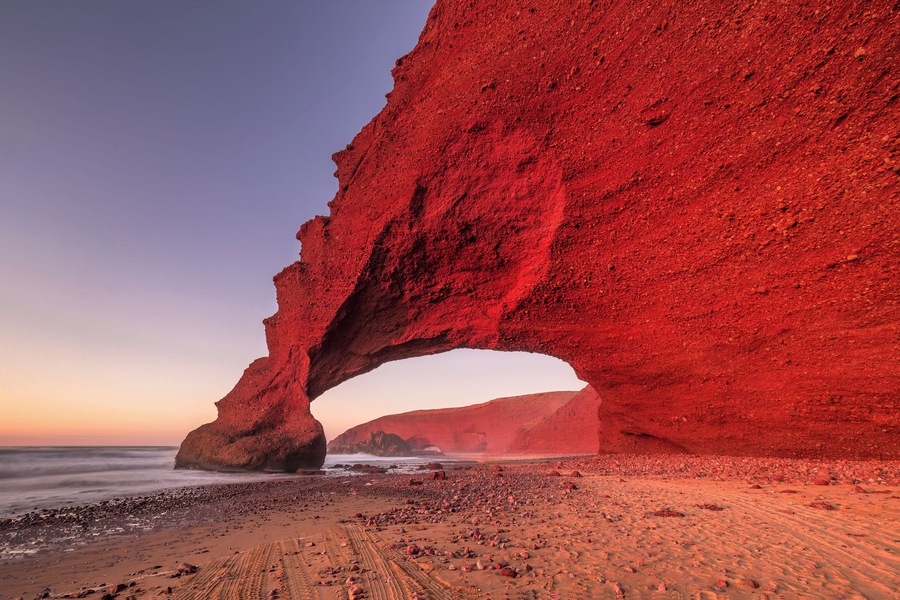 Sunset at red arches of Legzira beach, Sidi Ifni, Souss-Massa-Draa, Morocco.