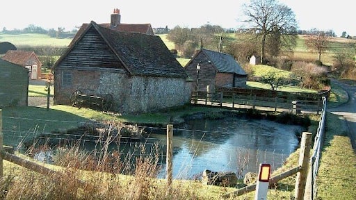 Slough Bottom Farm. This farm nestles in rolling countryside near the village of Saunderton. The pond was partly frozen due a sharp frost the previous night.