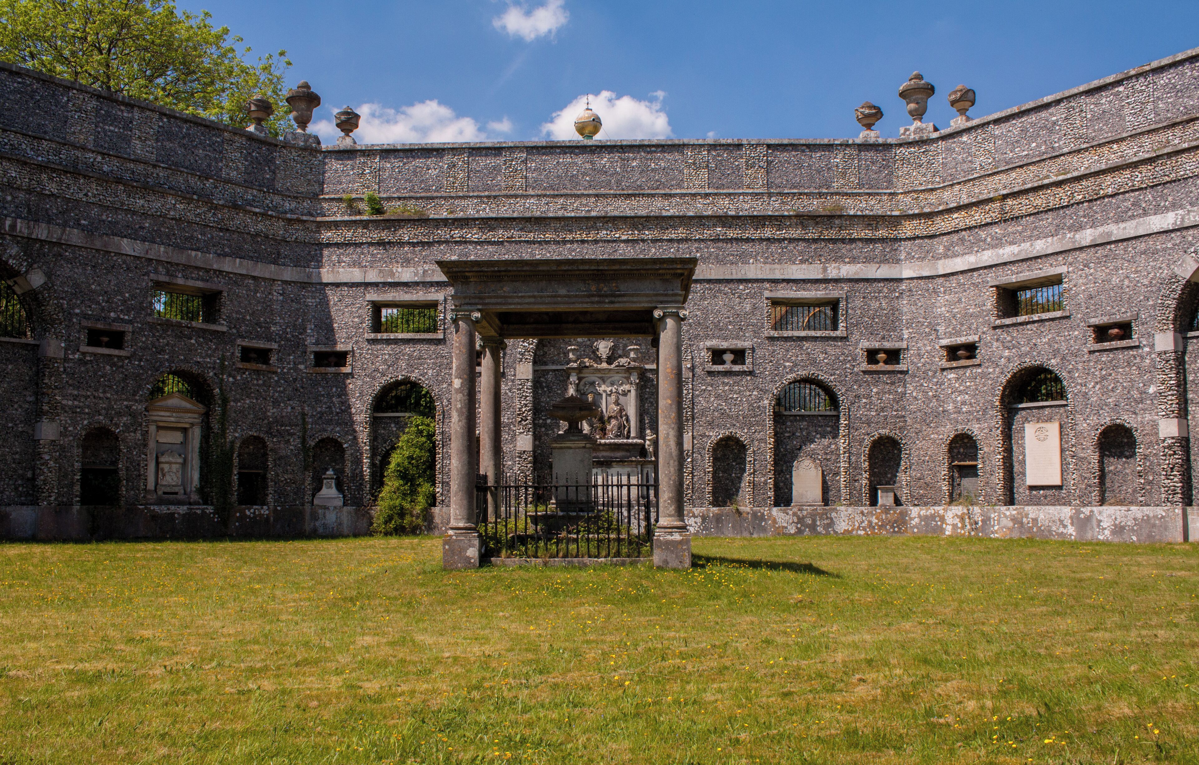 A historic stone building with arched windows and a central entrance.