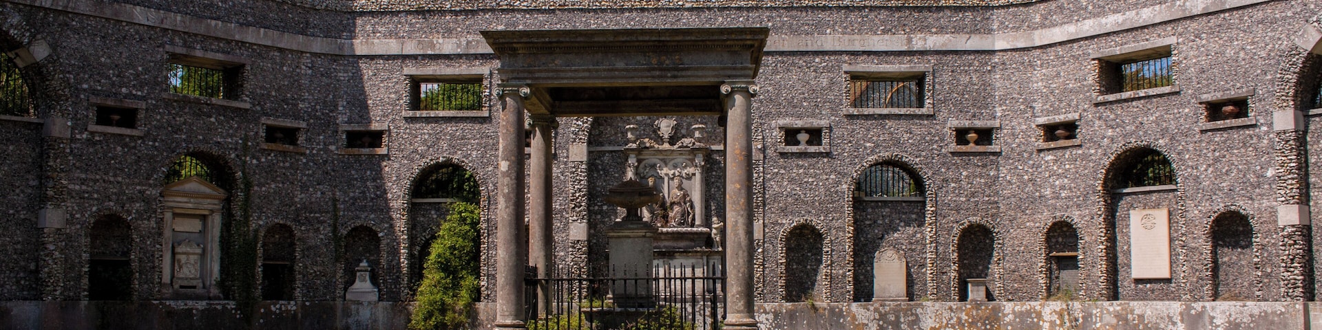 A historic stone building with arched windows and a central entrance.