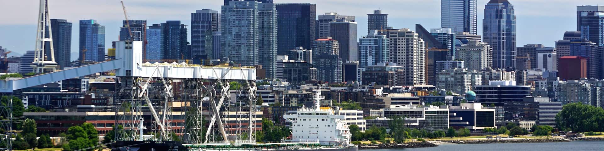 Seattle, Washington: View of the Seattle skyline and a cargo ship in Elliott Bay, from the Smith Cove Cruise Terminal at Pier #91.