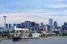 Seattle, Washington: View of the Seattle skyline and a cargo ship in Elliott Bay, from the Smith Cove Cruise Terminal at Pier #91.