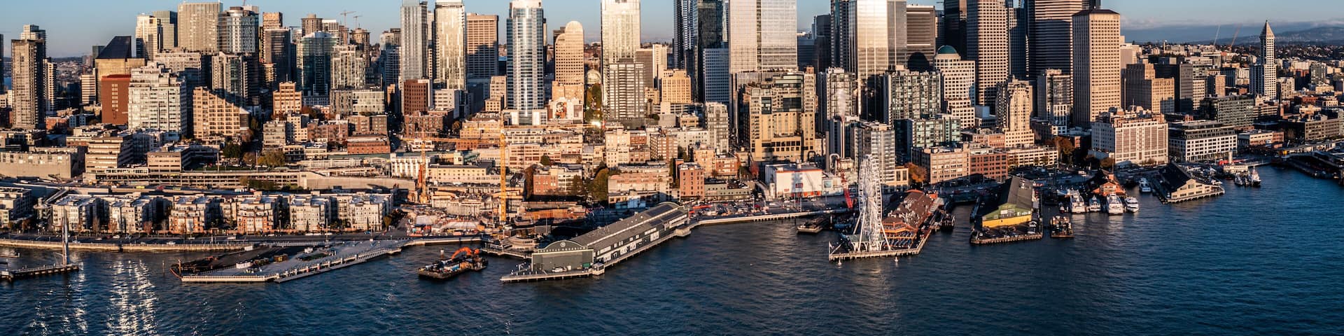 Seattle Downtown, Washington, USA, aerial view of Seattle Downtown and the Waterfront pier area with The Seattle Great Wheel during sunset - aerial panoramic view