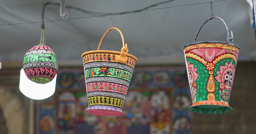 Traditional Buckets and Jugs made from wood material in authentic designs and painted with vibrant non toxic colors in Rajasthan, India.