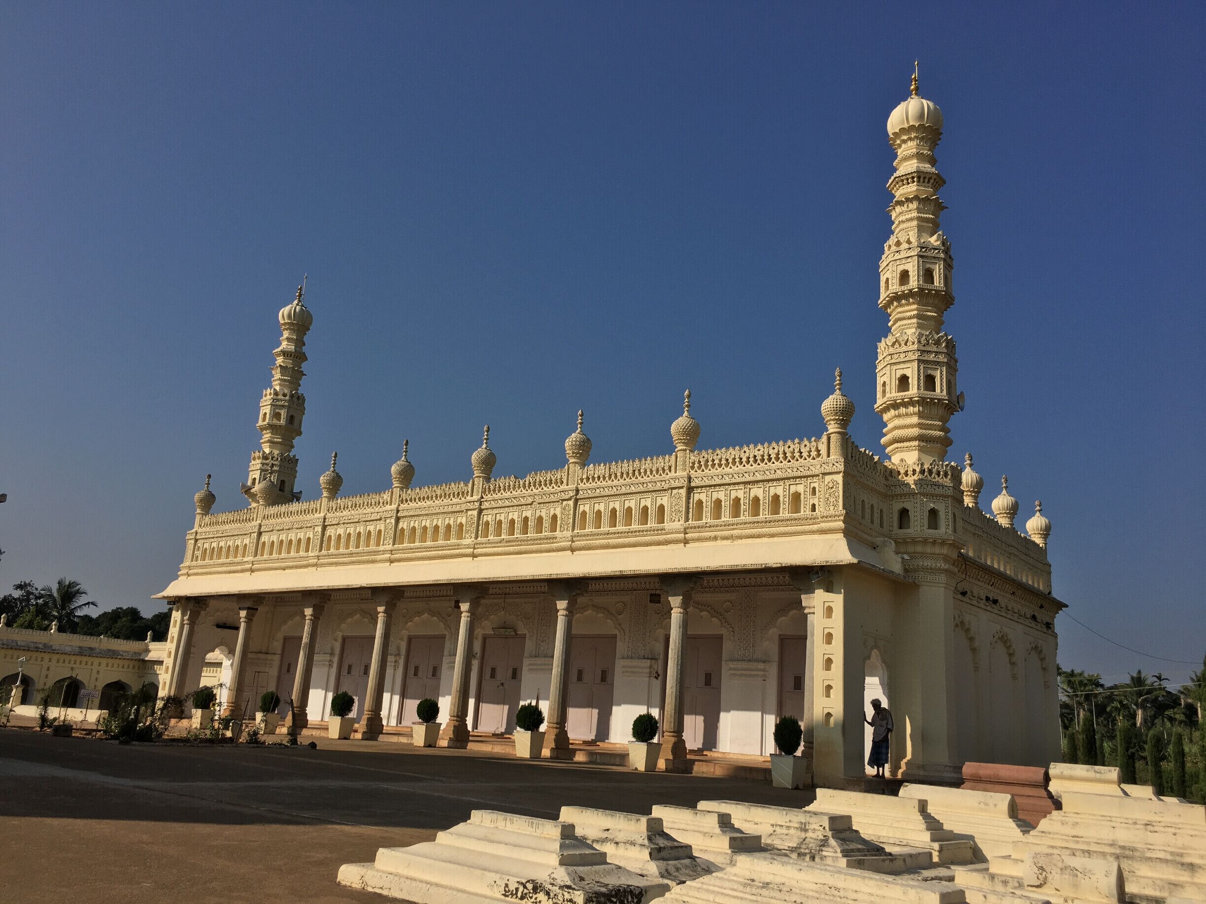 A large, ornate building with multiple domes and minarets, featuring intricate architectural details and a grand entrance.