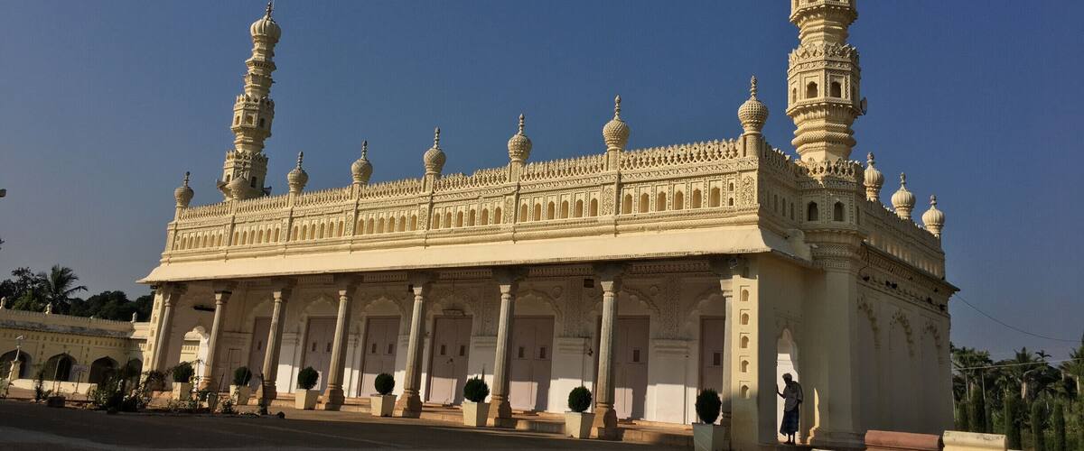 A large, ornate building with multiple domes and minarets, featuring intricate architectural details and a grand entrance.
