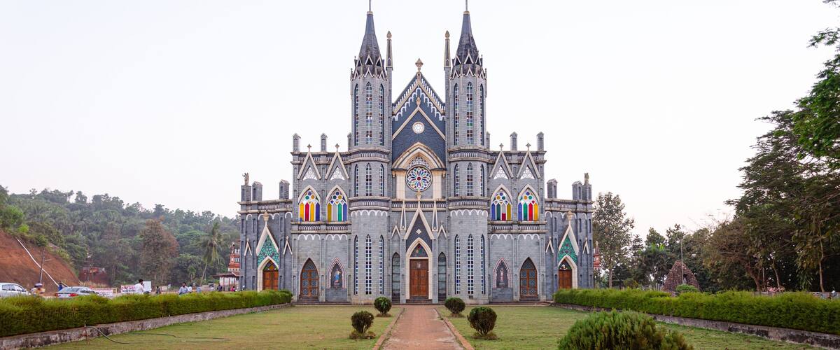 A Gothic-style church with twin spires and colorful stained glass windows.