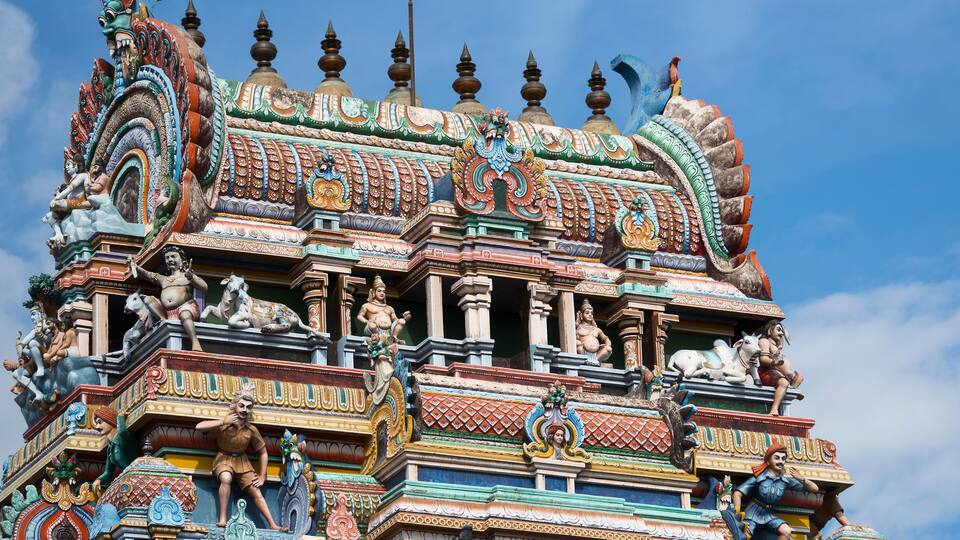 A colorful temple with intricate carvings and statues.