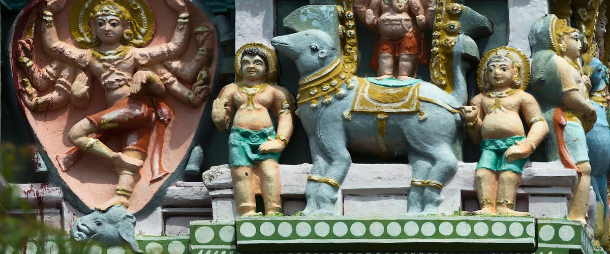 A temple with colorful statues of deities and elephants.