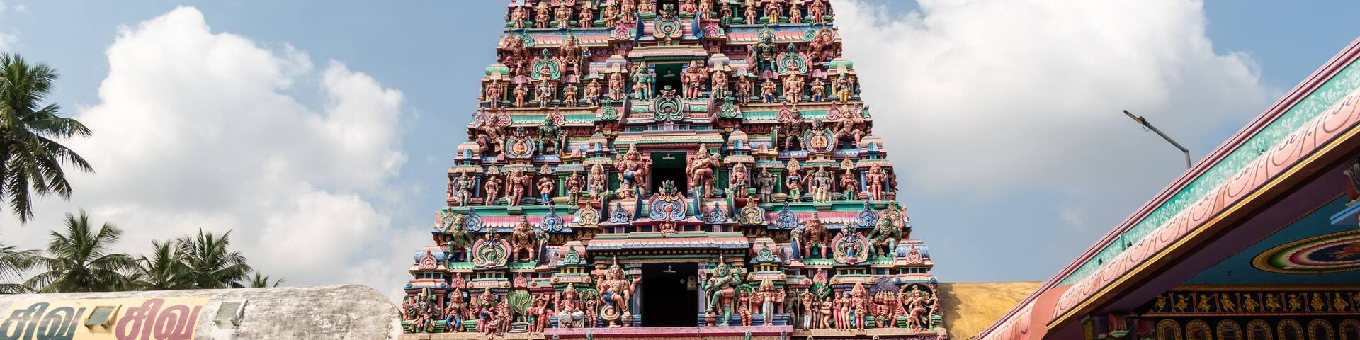 The tall gopuram entrance tower of an ancient Hindu temple around the town of Kumbakonam in Tamil Nadu.