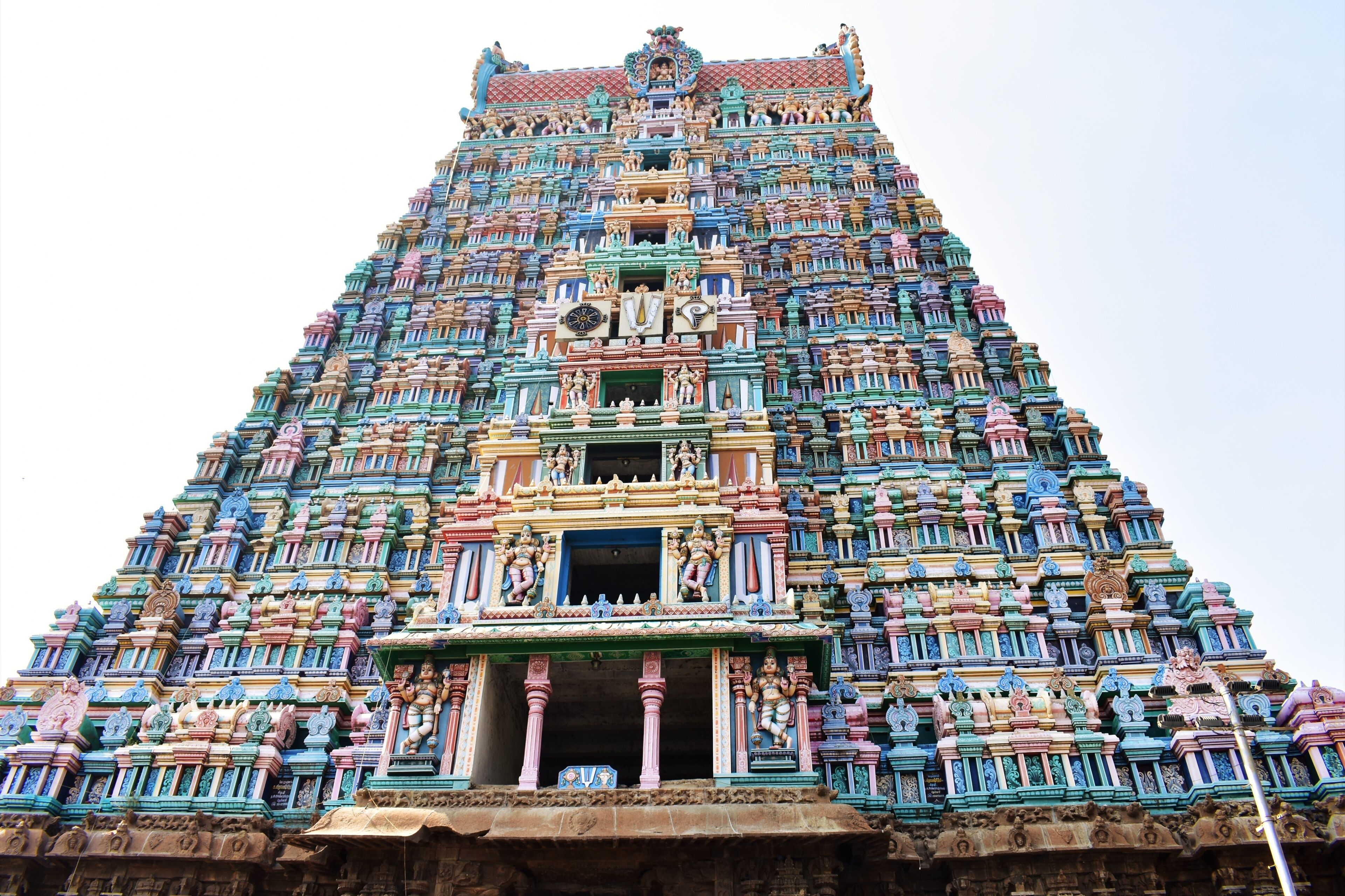 A multi-tiered temple with intricate carvings and statues.