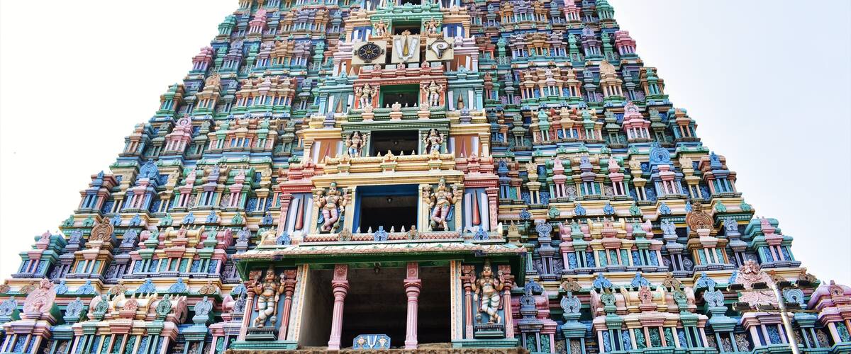 A multi-tiered temple with intricate carvings and statues.