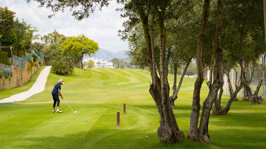 Real Club de Golf Guadalmina featuring golf as well as an individual femail