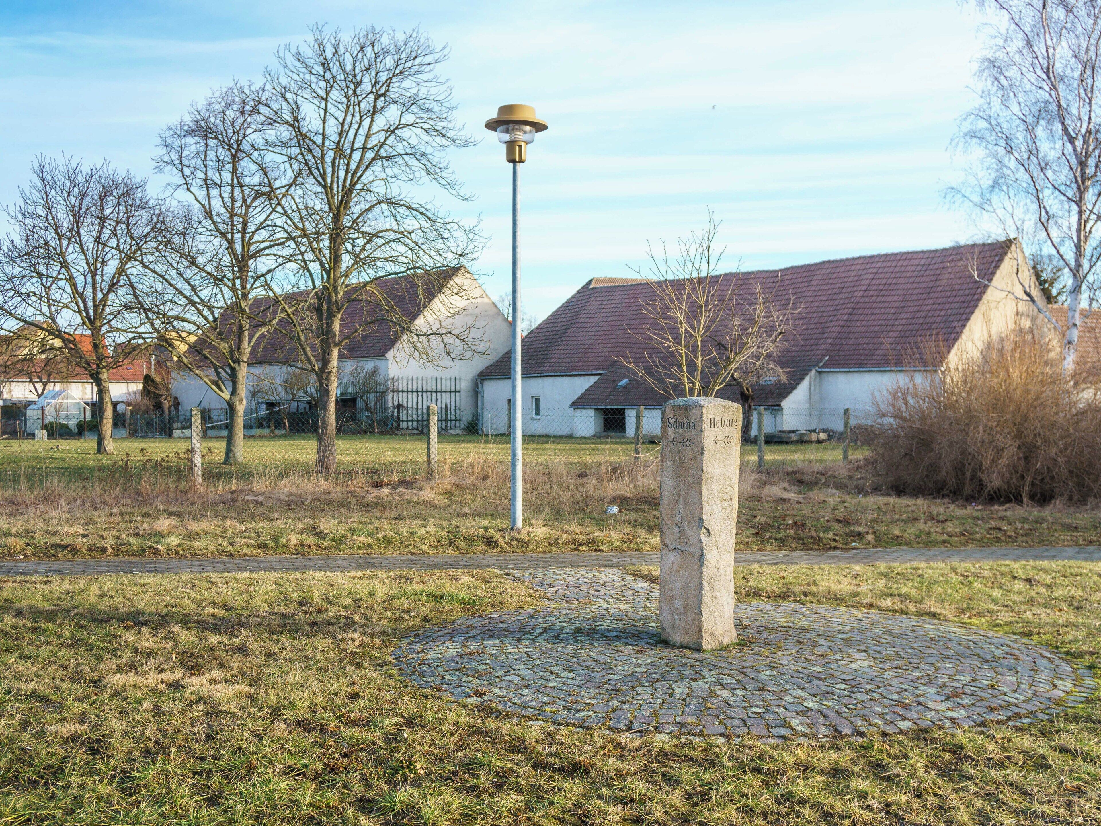 Wegweiserstein an der K 8983, Abzweig Schönaer Straße in Wildschütz Inschrift: Schöna ; Hohburg ; Richtungspfeile