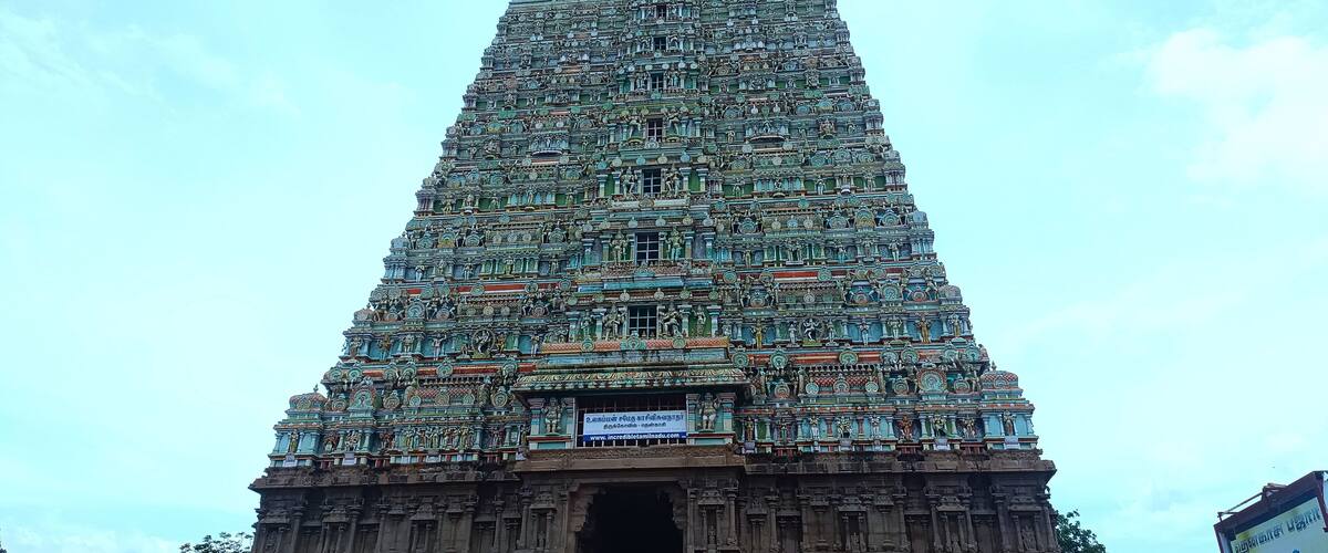 A detailed temple tower with intricate carvings and statues.