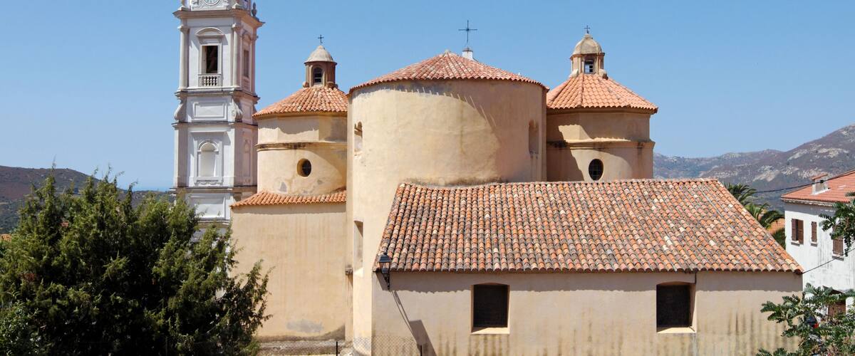 A church with a bell tower and domed roofs.