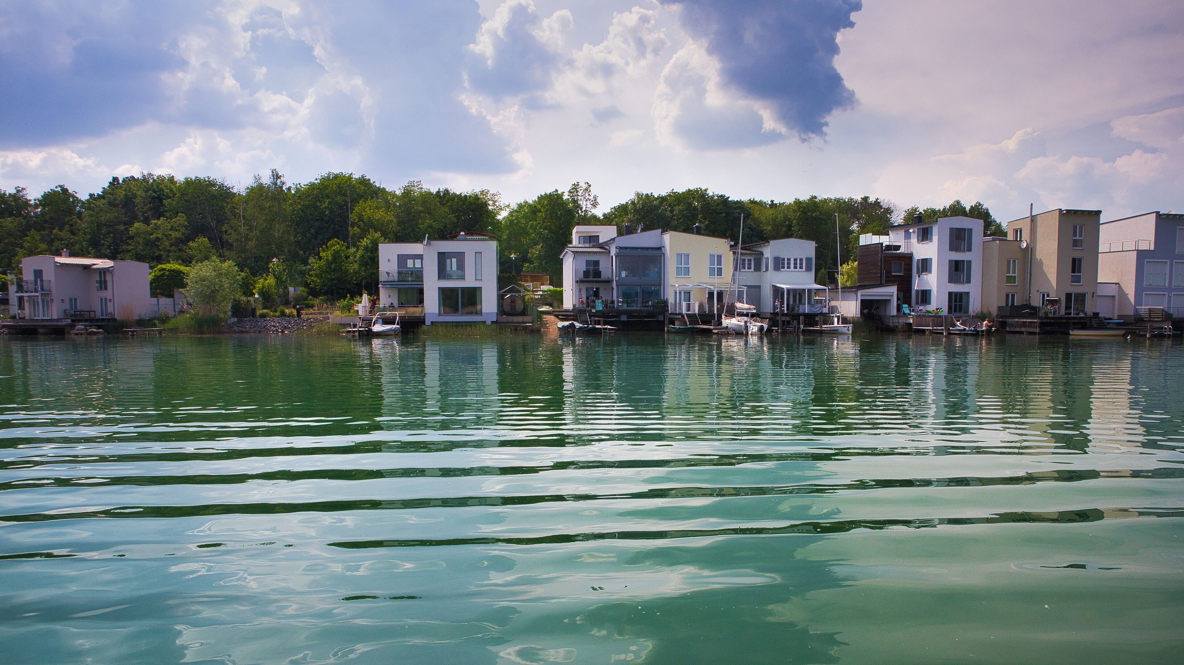 A waterfront with floating homes and calm water.