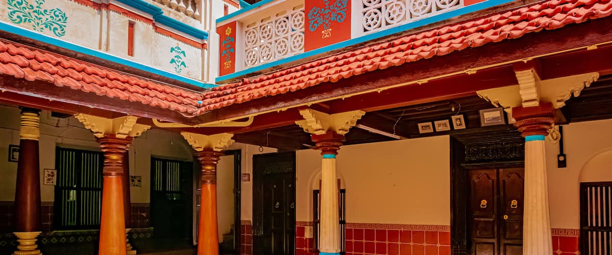 A traditional building with ornate columns, tiled floors, and decorative patterns.