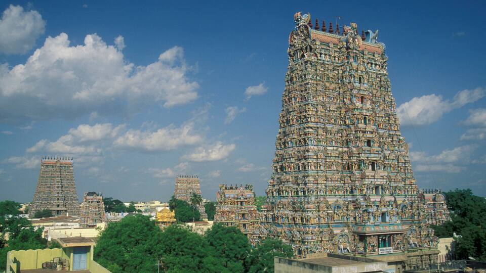 A large, intricately decorated temple with multiple tiers and statues.
