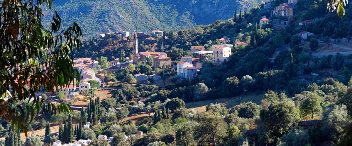 A mountainous landscape with a village nestled among the hills.