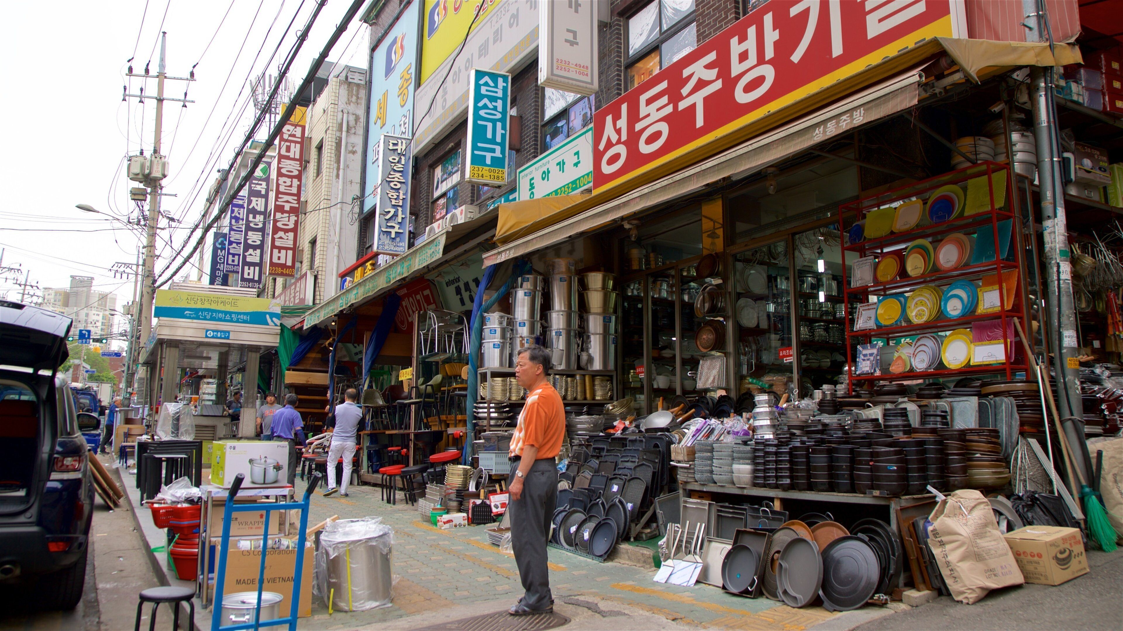 Gwangjang Traditional Market which includes signage as well as an individual male