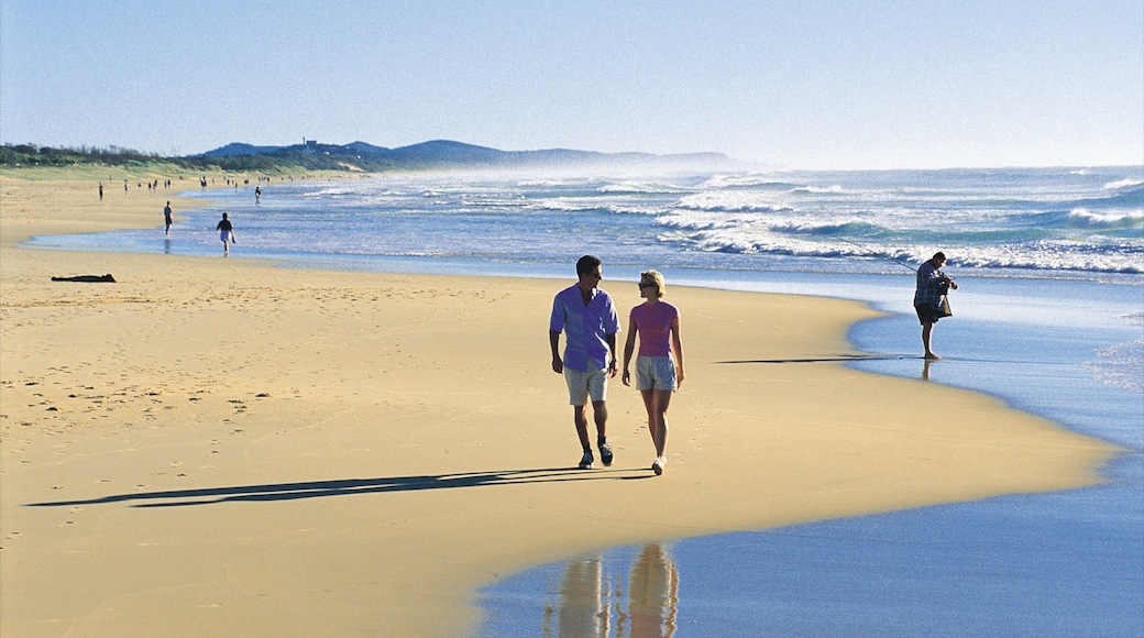 Coolum Beach showing a sandy beach and landscape views as well as a couple