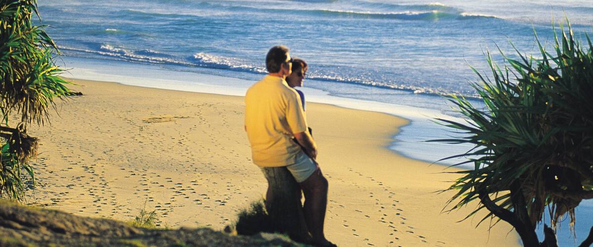 Coolum Beach which includes a sandy beach and a sunset as well as a couple
