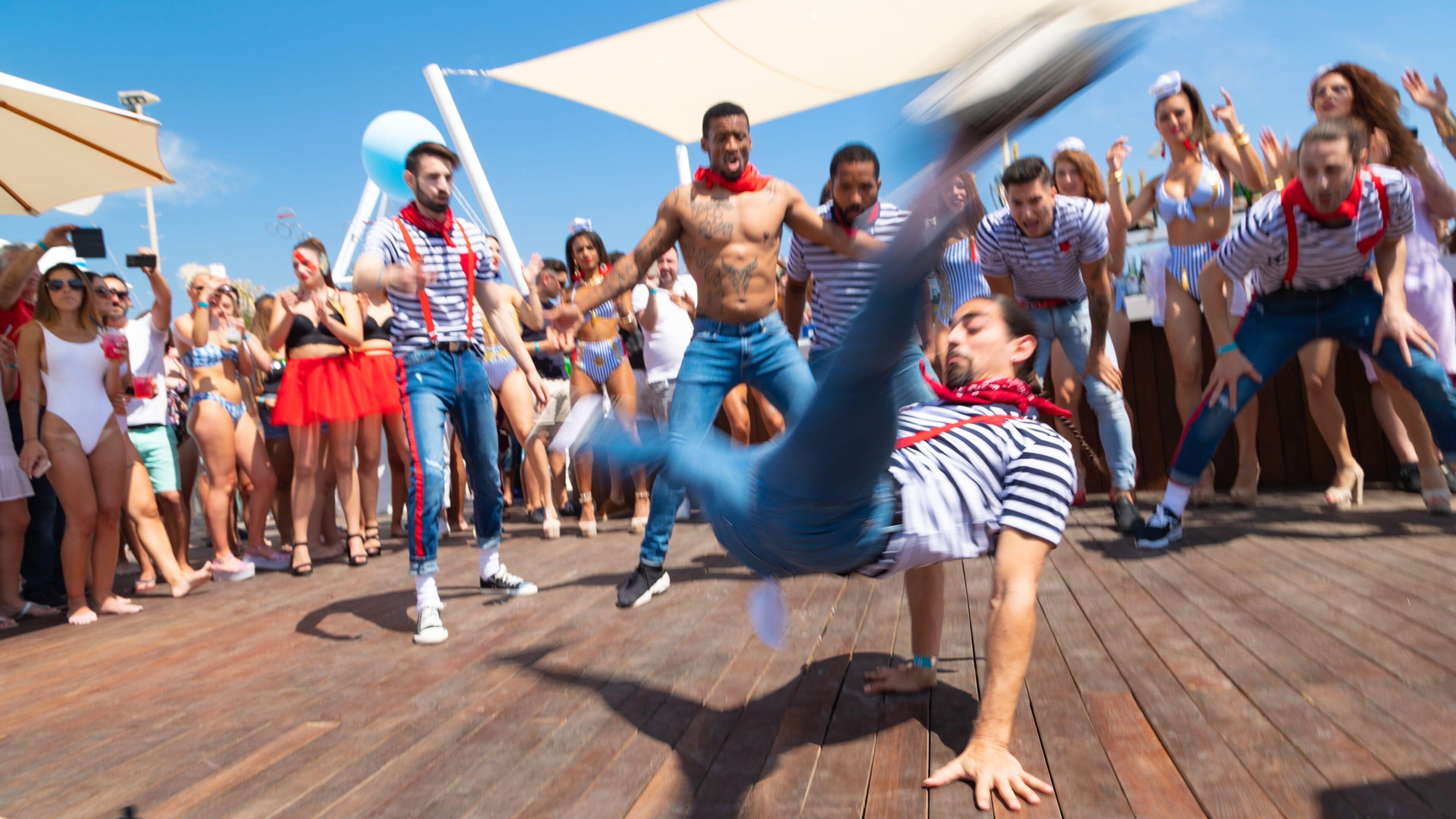 Funny Beach featuring street performance as well as a large group of people