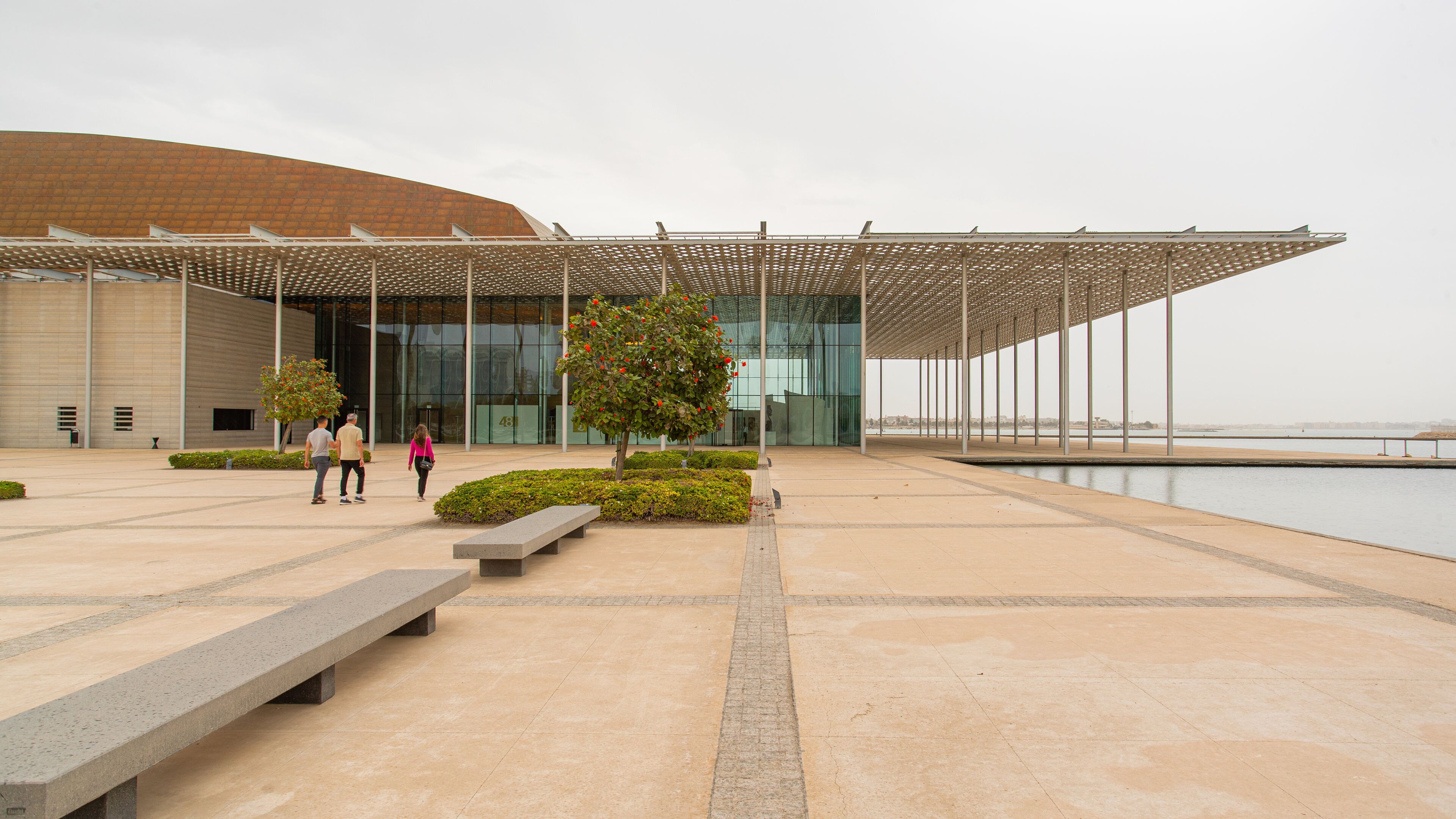 Bahrain National Theater featuring a square or plaza as well as a small group of people