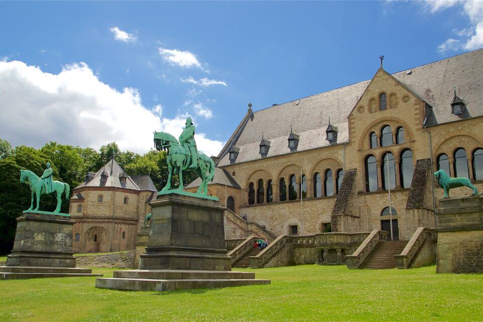 A historic building with statues of a man on horseback and a lion.