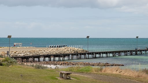 View of Emu Bay jetty, Kangaroo Island, South Australia. Clear blue sea and park bench.
