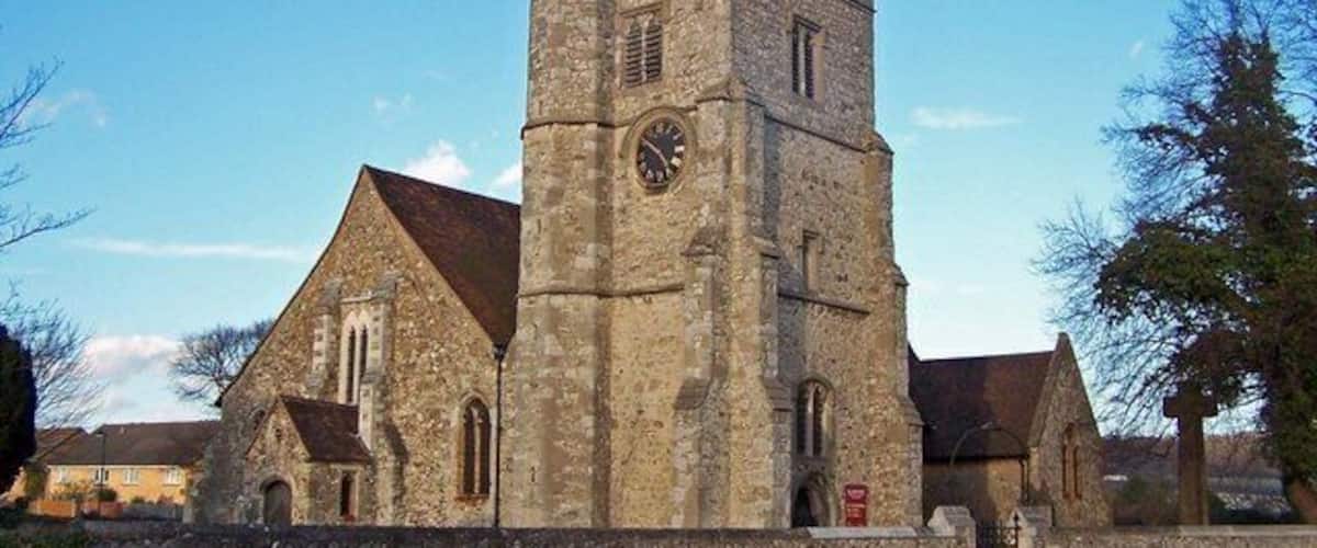 A historic church with a prominent tower and a clock.