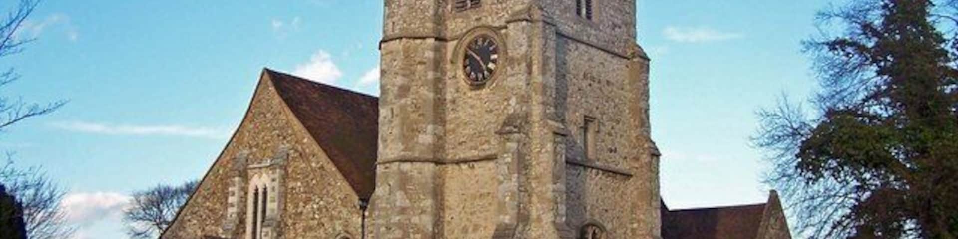 A historic church with a prominent tower and a clock.