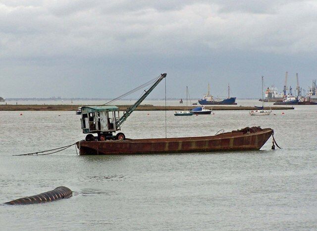 Barge with crane Moored off Rushenden Pier. The "Dinky Toy" crane looks like it might have seen better days...