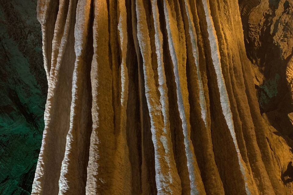 A large, smooth, vertical rock formation with a rounded top.