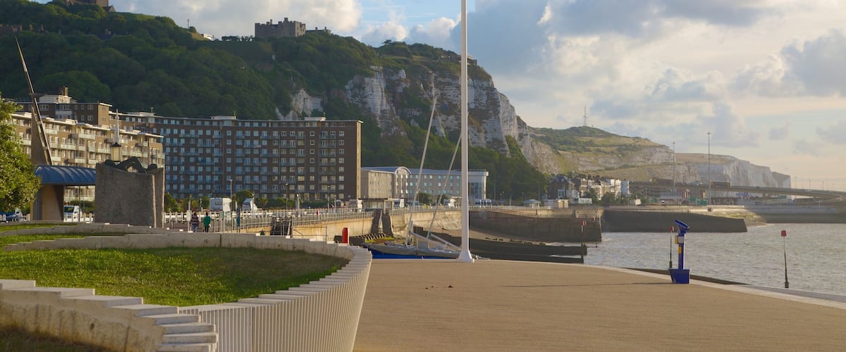 Dover Beach which includes mountains, a sandy beach and a coastal town