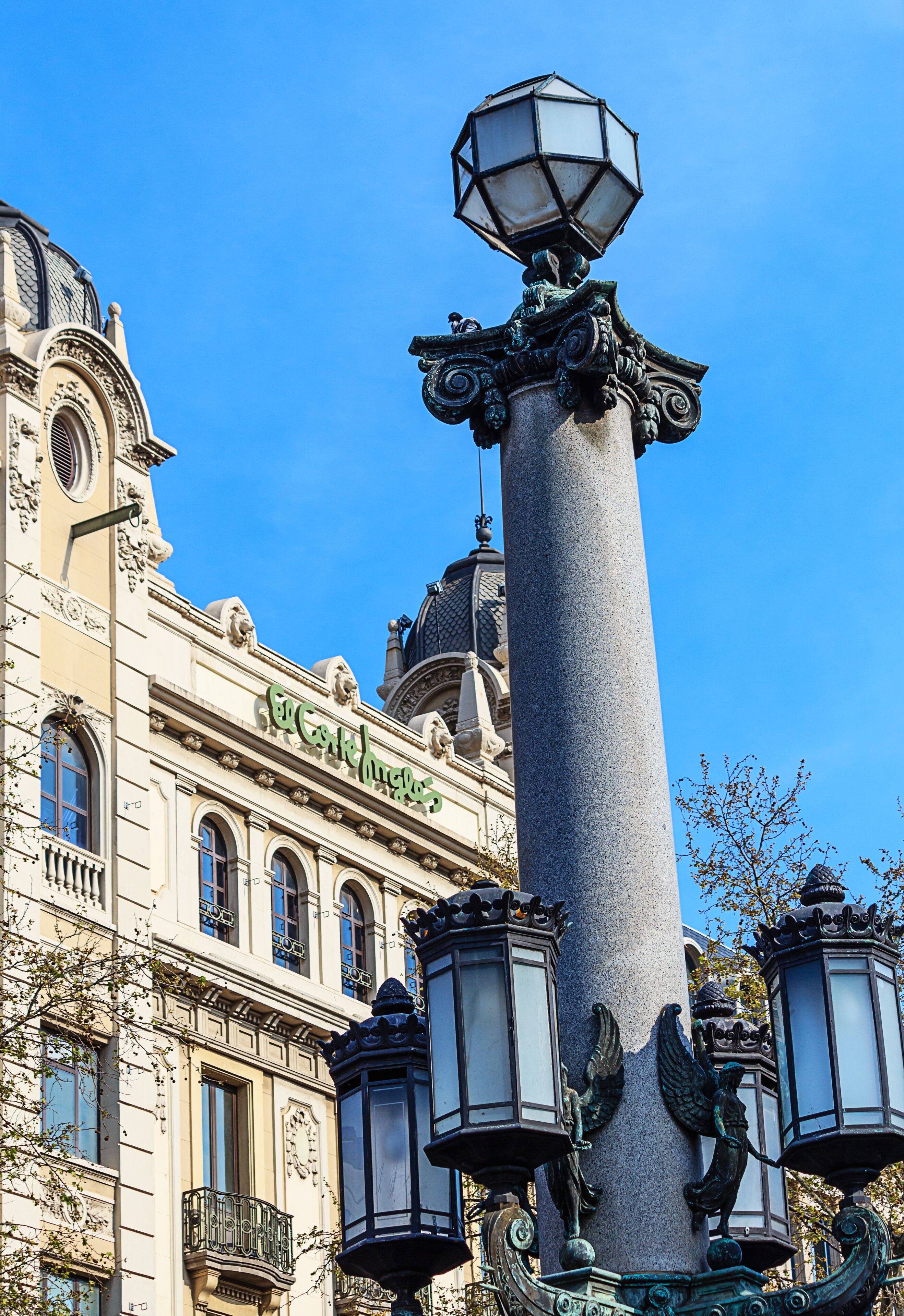Old tall street lamp on the Catalonia square in Barcelona, Spain