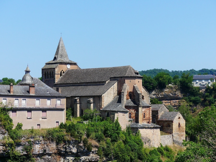 A historic stone church with a prominent tower and a clock.