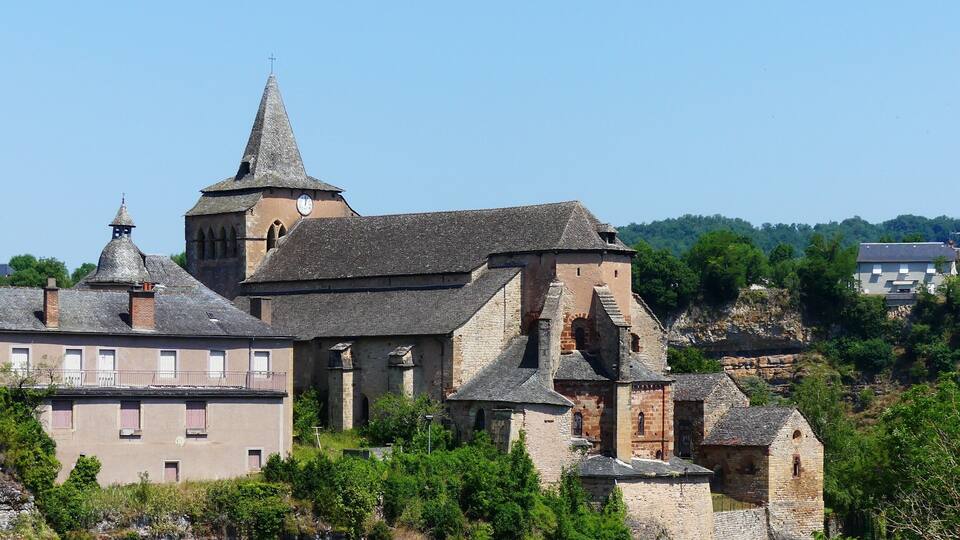 A historic stone church with a prominent tower and a clock.