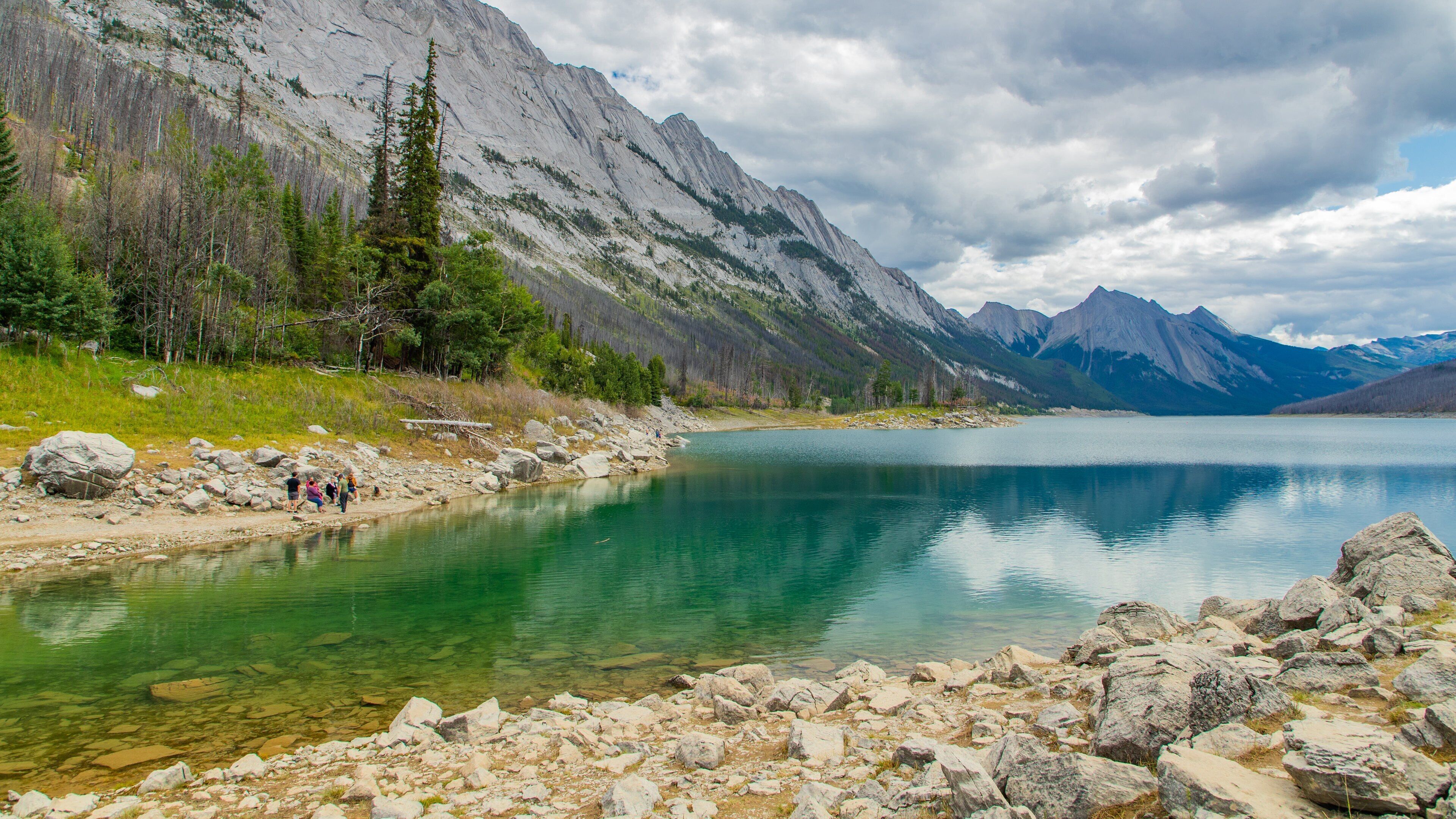 Medicine Lake featuring a lake or waterhole, mountains and a river or creek