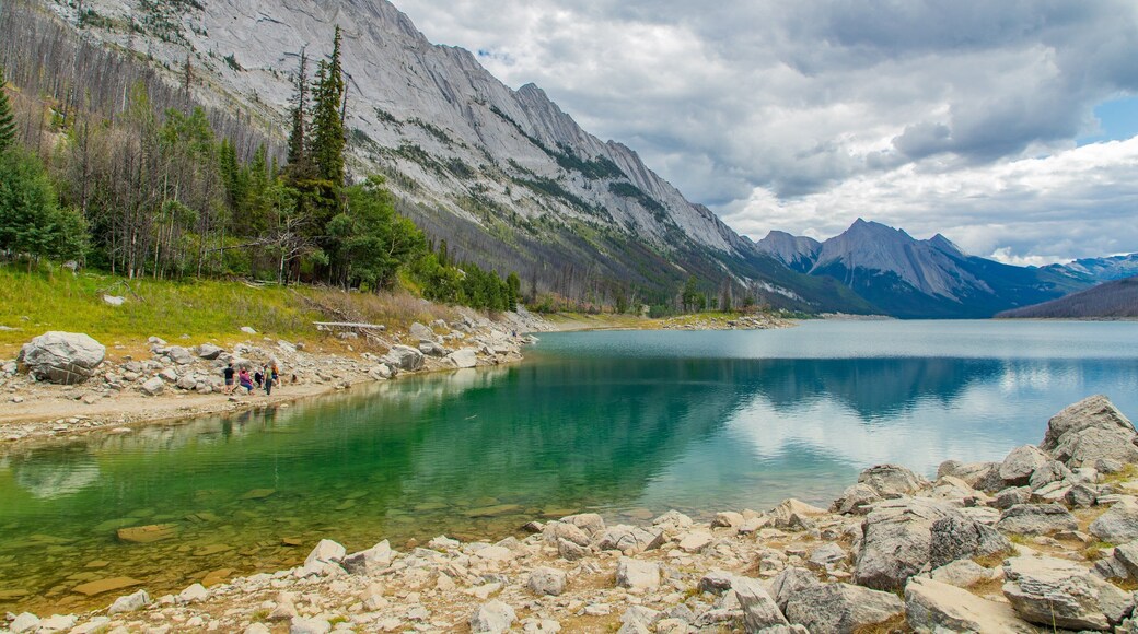 Medicine Lake featuring a lake or waterhole, mountains and a river or creek