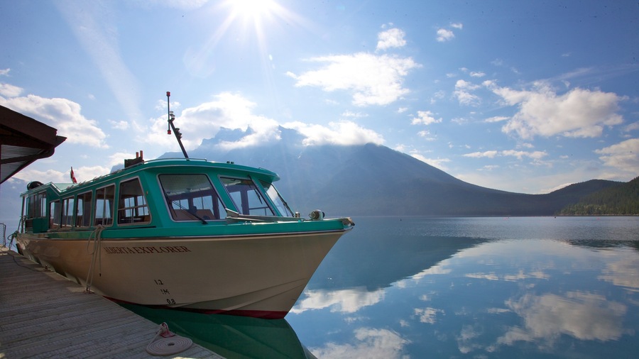 Lake Minnewanka which includes mountains, landscape views and a marina