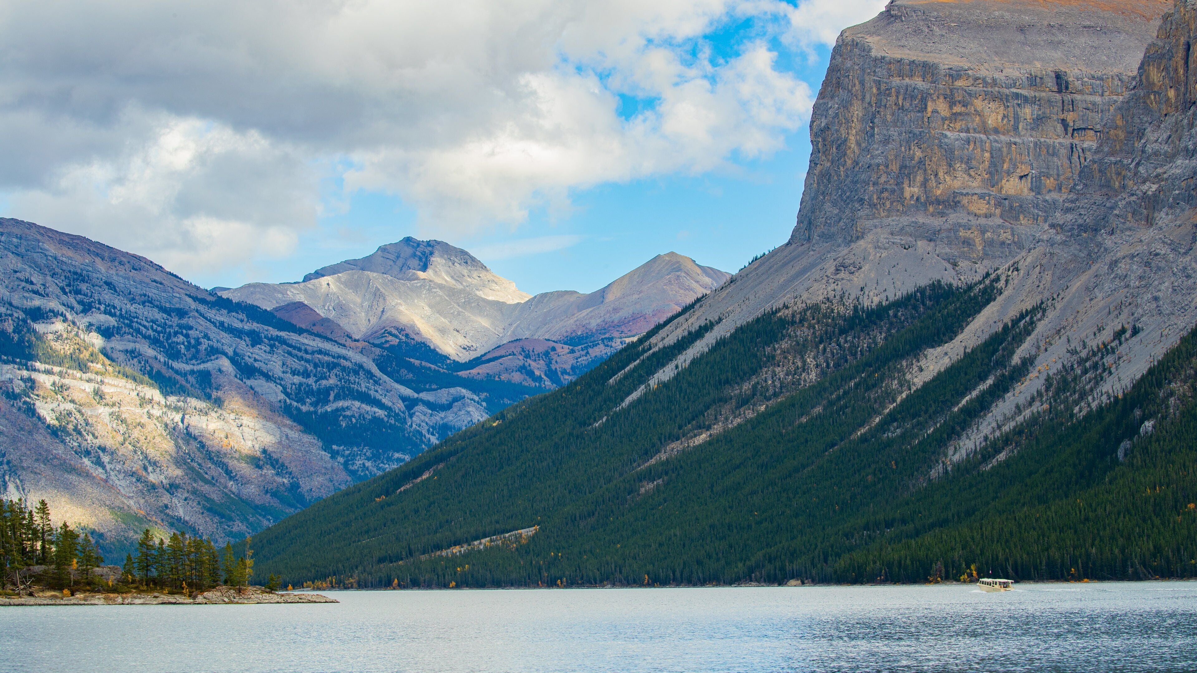 Lake Minnewanka featuring mountains and a lake or waterhole