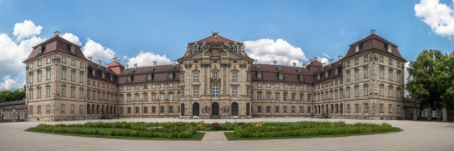 A large, historic building with a symmetrical facade, multiple windows, and a central entrance.
