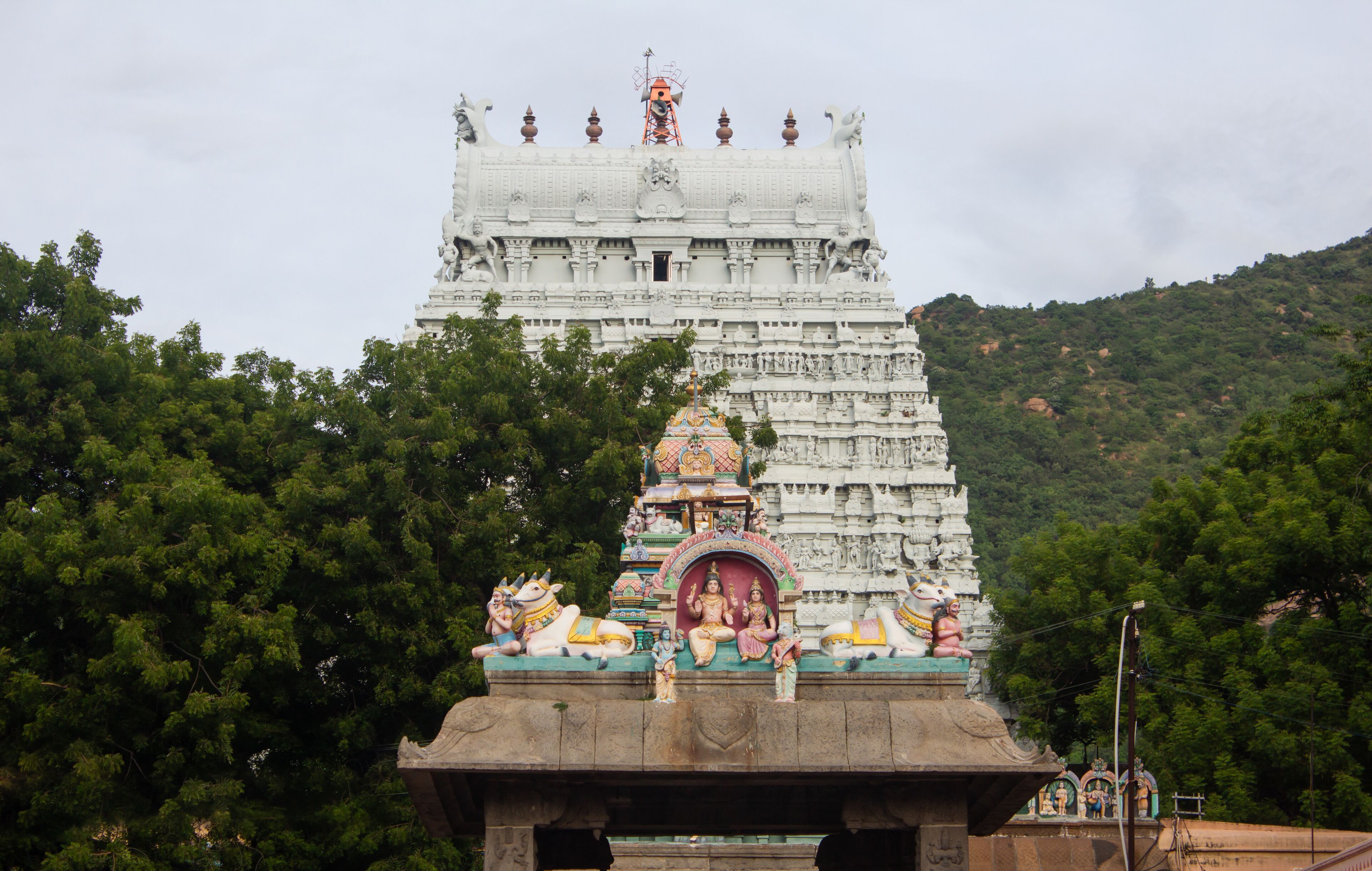 A temple with intricate carvings and a large statue on top.