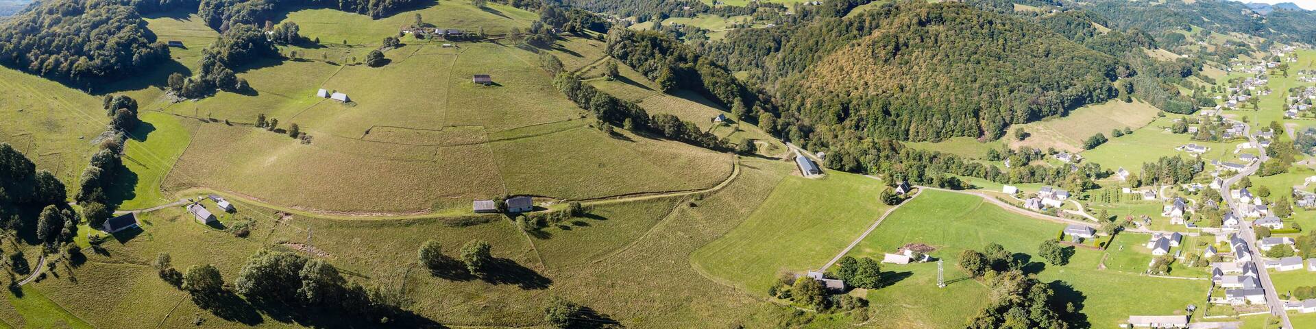 A mountainous landscape with a village nestled in the valley.