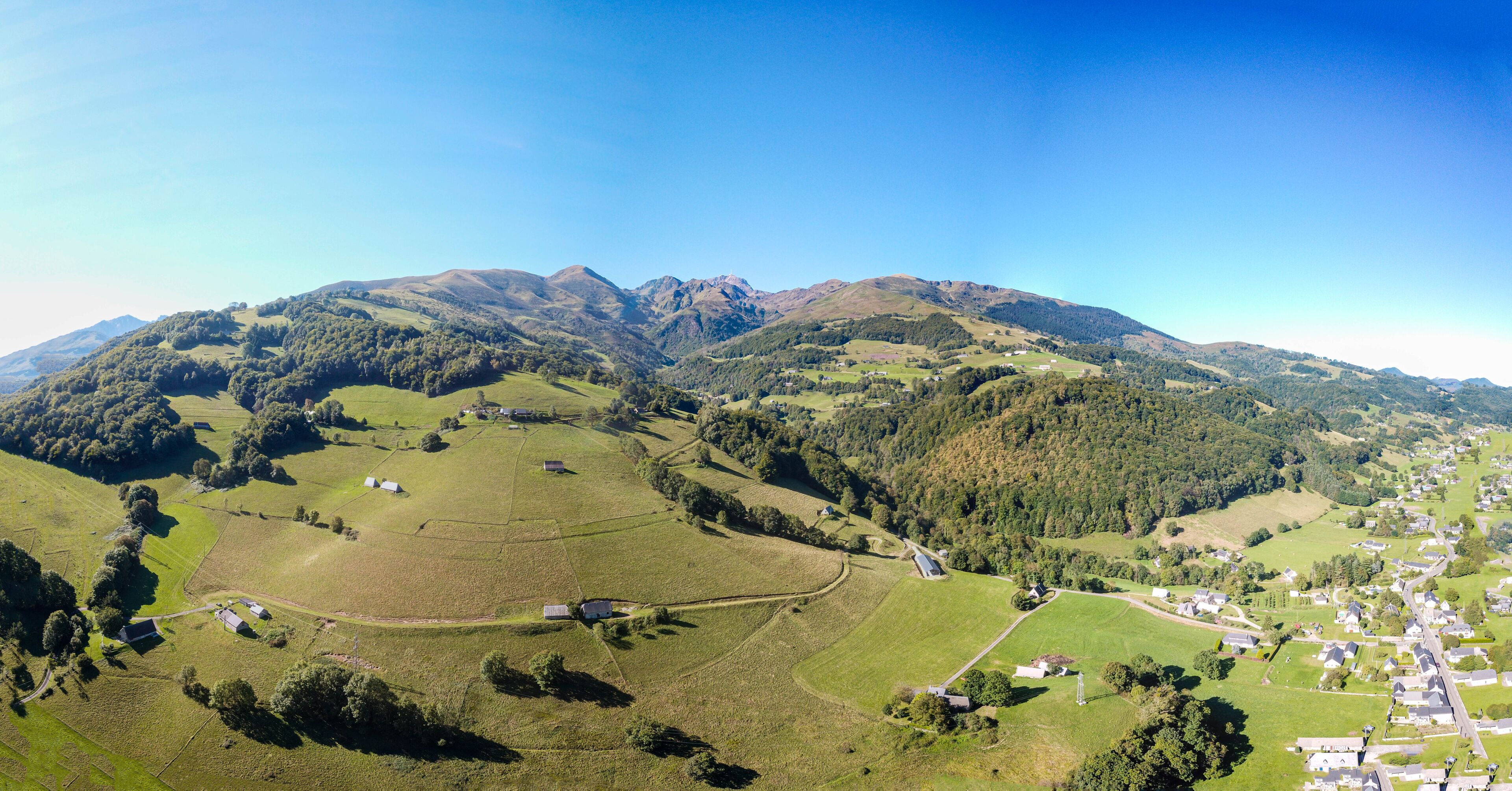 A mountainous landscape with a village nestled in the valley.
